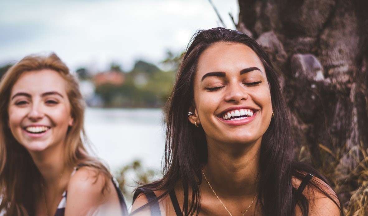 two teen girls smiling