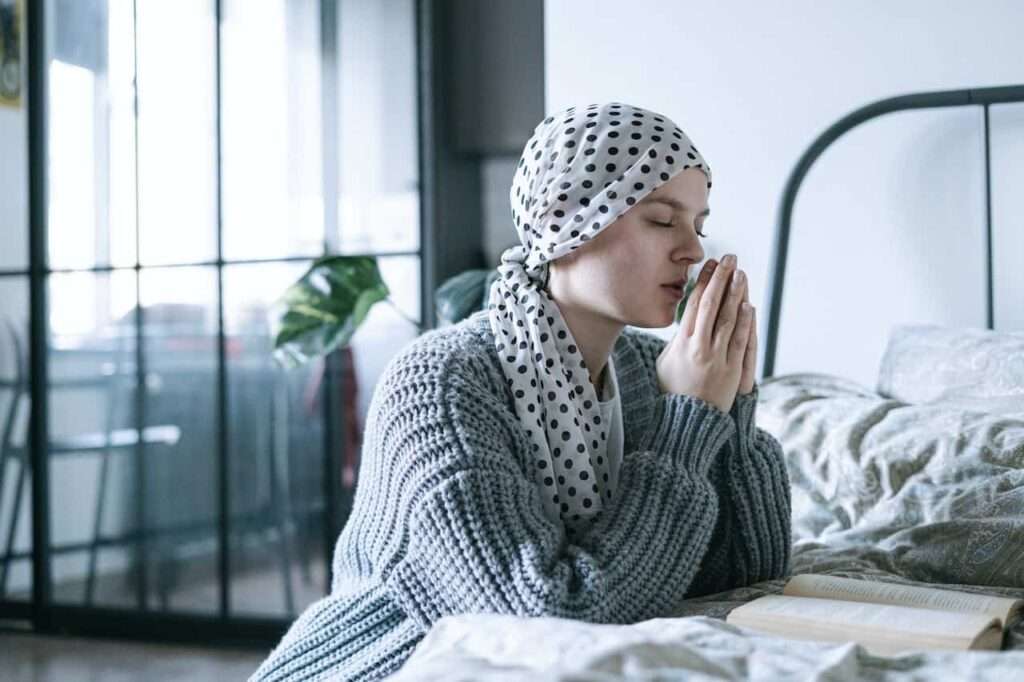 woman praying in her room